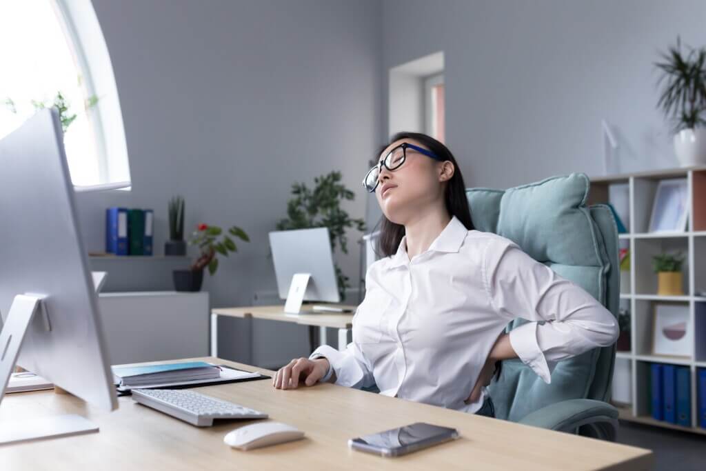 tired-female-office-worker-massaging-her-back-asi-2022-12-08-03-59-50-utc (1)-min